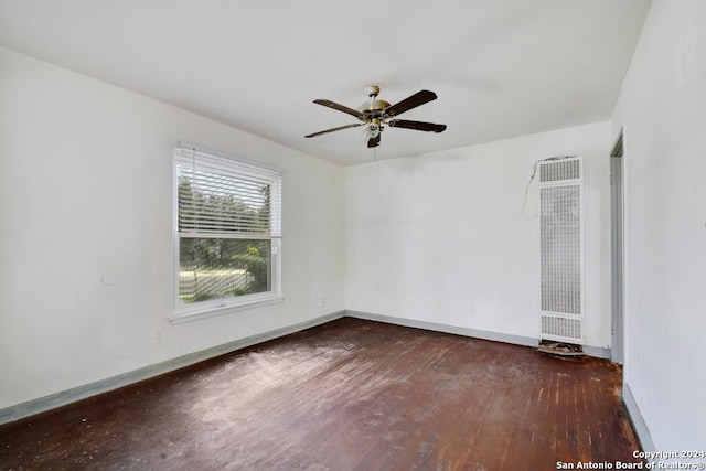 spare room featuring ceiling fan and dark wood-type flooring