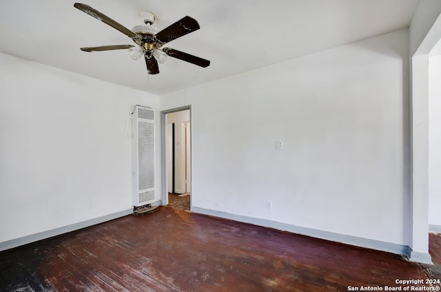 empty room featuring dark hardwood / wood-style flooring and ceiling fan