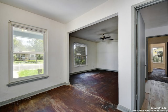 spare room with dark wood-type flooring and ceiling fan