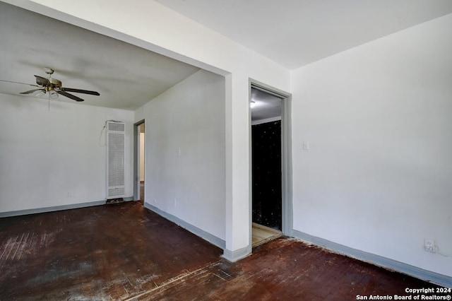 spare room featuring ceiling fan and dark hardwood / wood-style floors