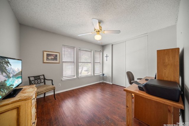 office area featuring ceiling fan, a textured ceiling, baseboards, and wood finished floors