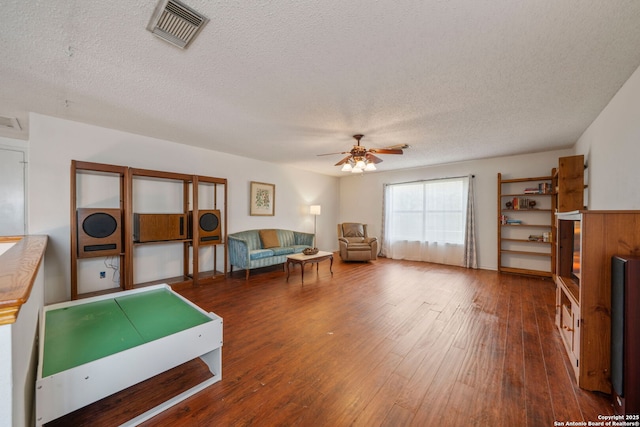 interior space featuring visible vents, a textured ceiling, hardwood / wood-style floors, and ceiling fan