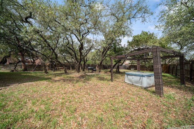 view of yard featuring a gazebo, a fenced backyard, and a pool