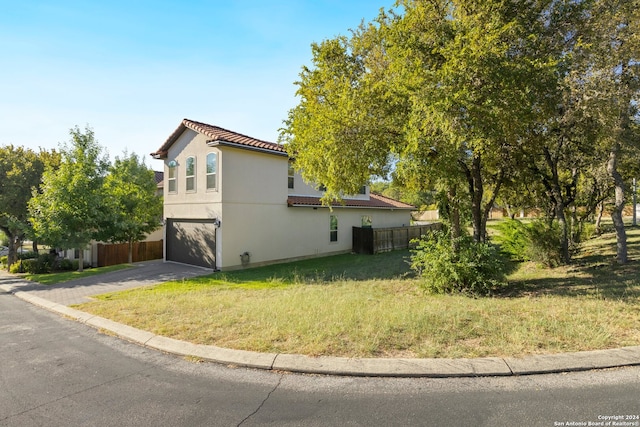 view of home's exterior featuring a yard and a garage