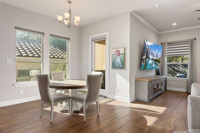 dining room featuring ornamental molding, a chandelier, and hardwood / wood-style floors