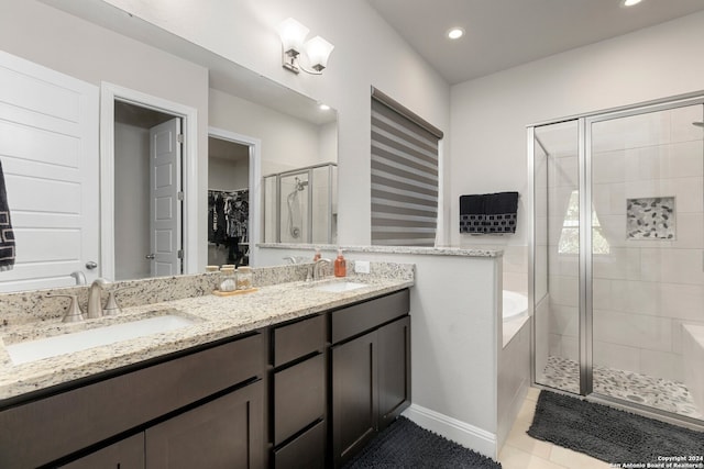 bathroom with tile patterned flooring, vanity, and separate shower and tub