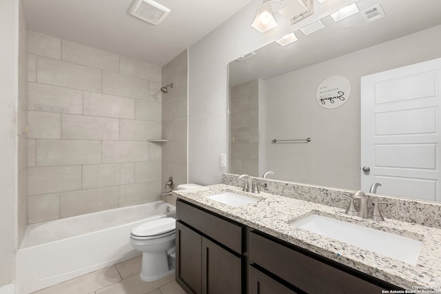 full bathroom featuring vanity, toilet, tile patterned floors, and tiled shower / bath