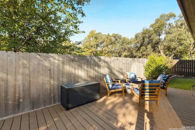 wooden terrace with an outdoor hangout area