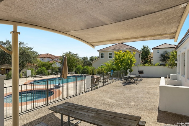 view of patio / terrace with a fenced in pool