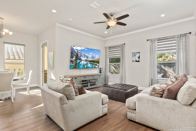 living room with ornamental molding, a wealth of natural light, and hardwood / wood-style flooring