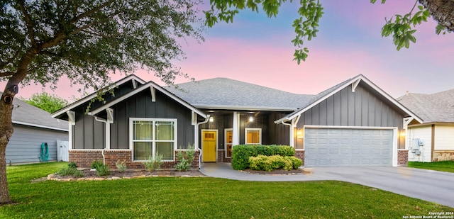 craftsman house featuring a garage and a yard