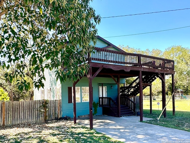 exterior space featuring a playground, a lawn, and a wooden deck