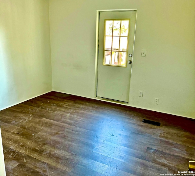 spare room featuring dark hardwood / wood-style floors