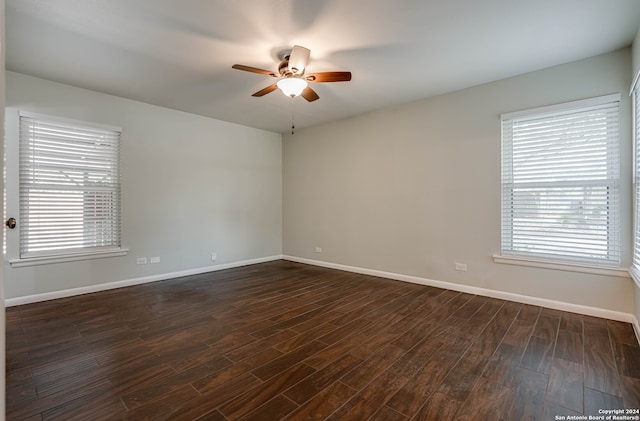 unfurnished room featuring ceiling fan, a healthy amount of sunlight, and dark hardwood / wood-style flooring