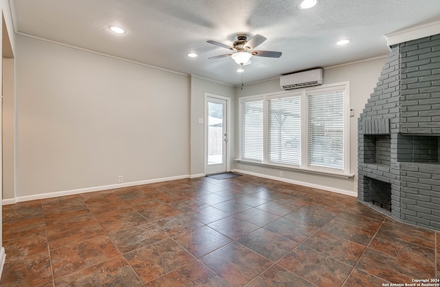 unfurnished living room featuring a brick fireplace, crown molding, an AC wall unit, and ceiling fan