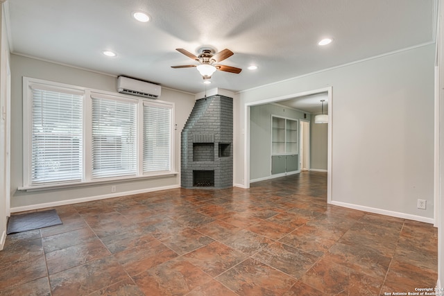 unfurnished living room featuring a brick fireplace, ceiling fan, crown molding, and a wall mounted air conditioner