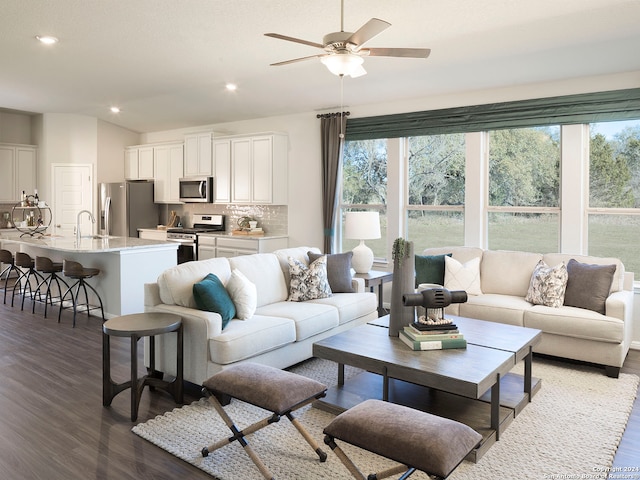 living room with ceiling fan, dark wood-type flooring, and sink