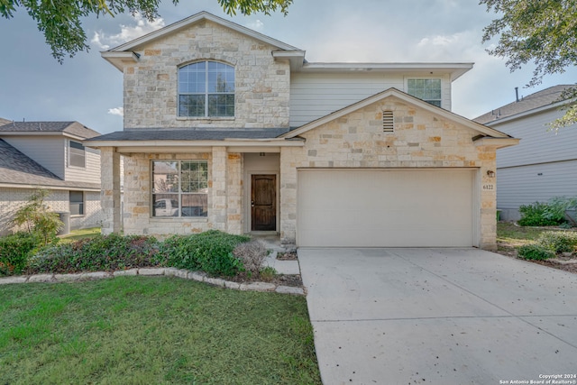 view of front facade featuring a garage, concrete driveway, and a front lawn