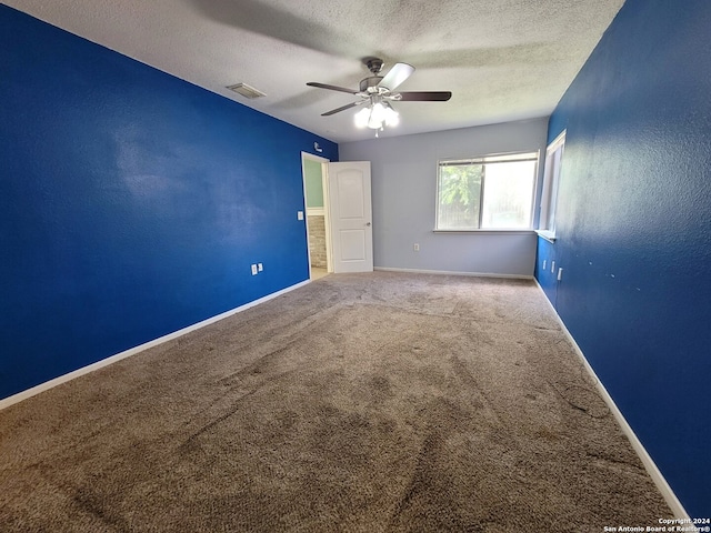 unfurnished bedroom with carpet floors, a textured ceiling, and ceiling fan