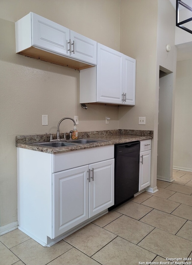 kitchen with dishwasher, white cabinetry, and sink