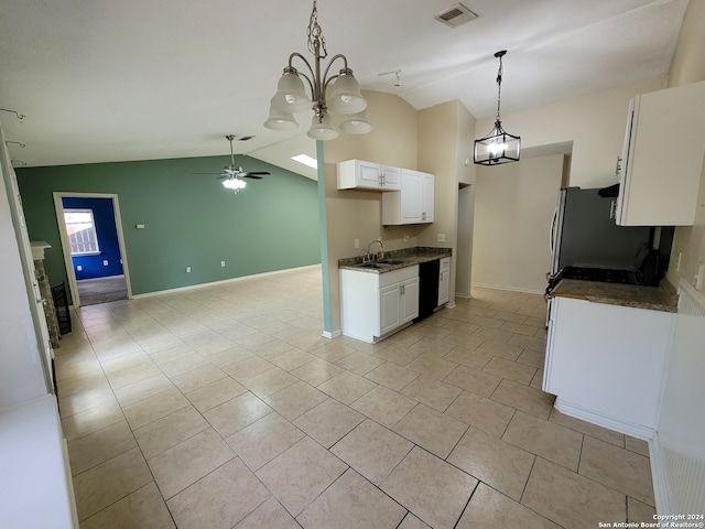 kitchen with sink, ceiling fan with notable chandelier, white cabinets, vaulted ceiling, and stainless steel fridge