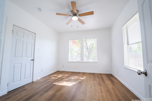 empty room featuring ceiling fan and dark hardwood / wood-style floors