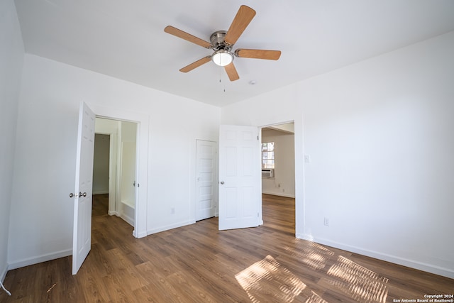 unfurnished bedroom featuring cooling unit, ceiling fan, and hardwood / wood-style flooring