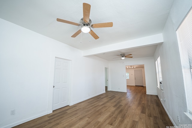 empty room with ceiling fan and dark hardwood / wood-style flooring