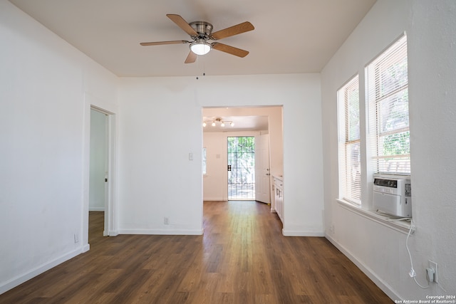 spare room featuring cooling unit, dark hardwood / wood-style floors, and ceiling fan