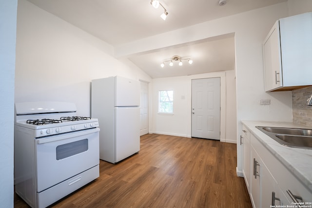 kitchen with white cabinets, lofted ceiling, white appliances, hardwood / wood-style floors, and decorative backsplash