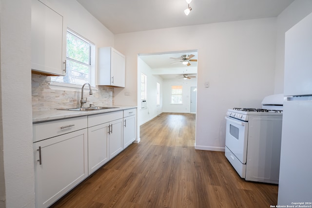 kitchen with white cabinets, ceiling fan, gas range gas stove, and sink