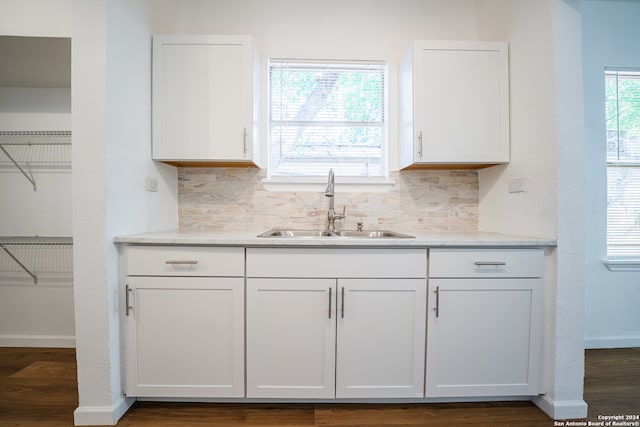 kitchen with sink, decorative backsplash, and white cabinetry