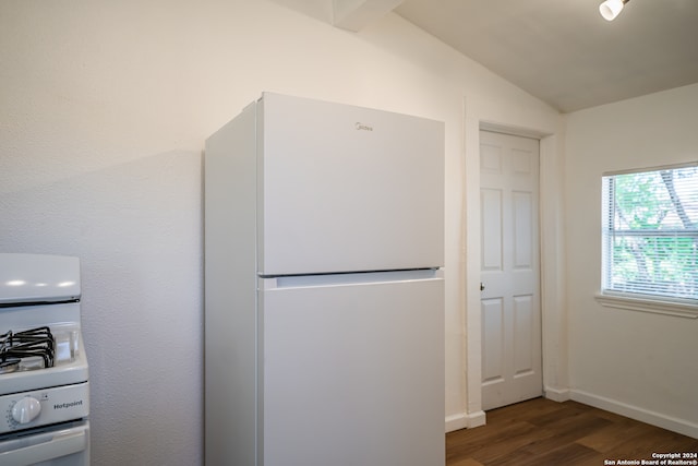 kitchen featuring white appliances, vaulted ceiling, and dark hardwood / wood-style flooring