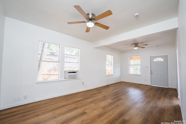 entryway featuring a textured ceiling, cooling unit, dark hardwood / wood-style flooring, and ceiling fan