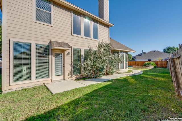 rear view of house with a lawn