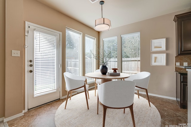 dining space with tile patterned floors and a wealth of natural light