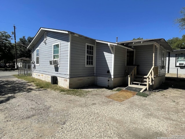 exterior space with fence, cooling unit, and crawl space