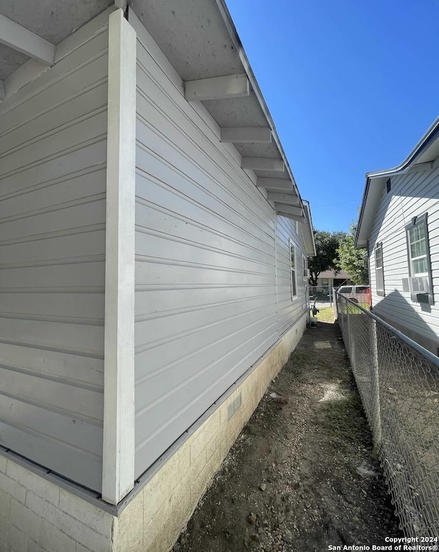 view of property exterior featuring crawl space and fence