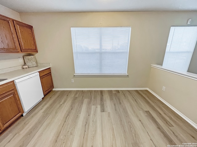 kitchen with white dishwasher and light hardwood / wood-style flooring