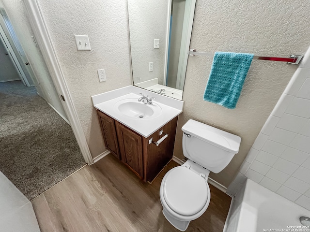 bathroom with vanity, toilet, a shower, and hardwood / wood-style floors