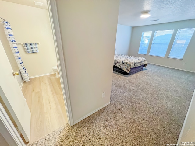 unfurnished bedroom featuring a textured ceiling and hardwood / wood-style floors