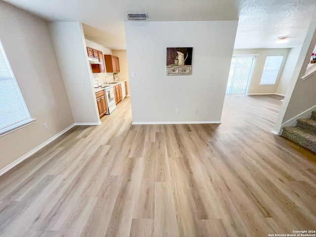 interior space with light hardwood / wood-style flooring and a textured ceiling