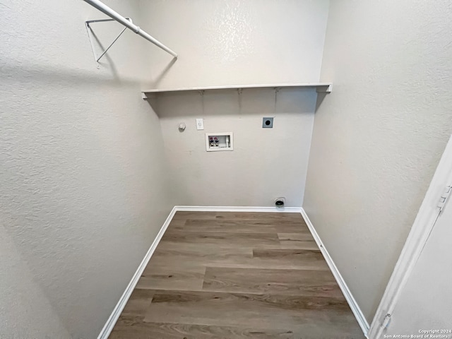 clothes washing area with hookup for a washing machine, electric dryer hookup, and hardwood / wood-style flooring