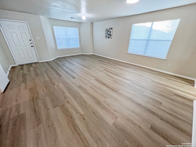 unfurnished living room featuring light wood-type flooring