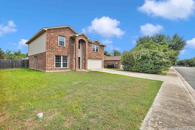 view of front of home with a garage and a front lawn