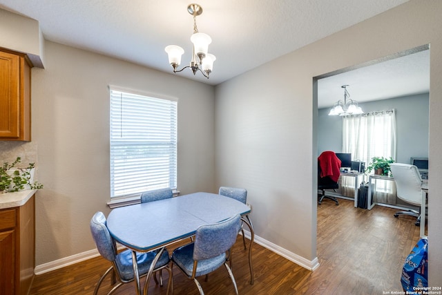 dining room featuring a chandelier, dark wood-style flooring, and baseboards