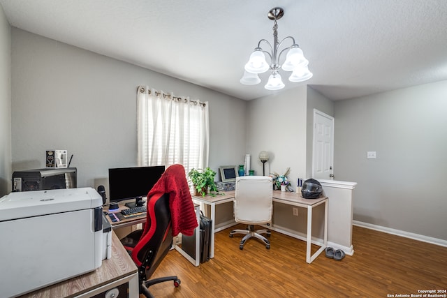 home office with a notable chandelier and wood-type flooring