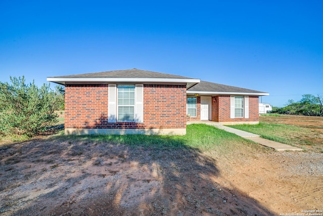 ranch-style home with a front lawn and brick siding