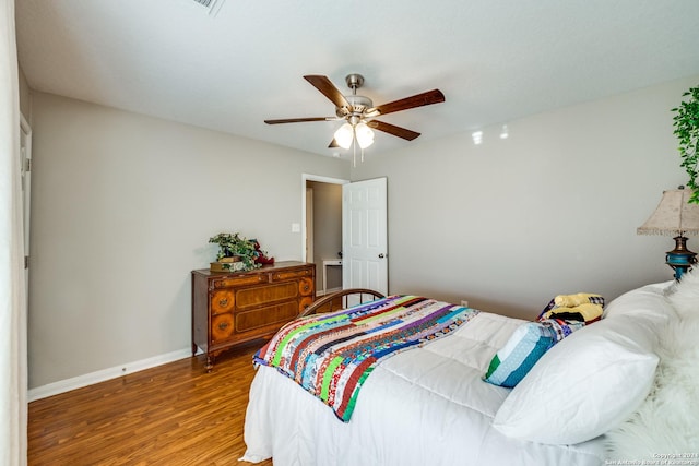 bedroom with baseboards, ceiling fan, and wood finished floors