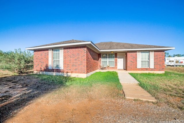 ranch-style house with brick siding and a shingled roof